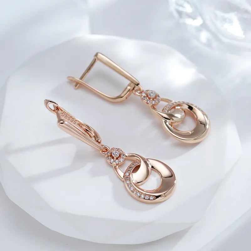 Boucles d'oreilles pendantes Anneaux enlacés, bijou en plaqué or rose