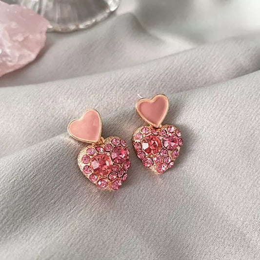 boucles d'oreilles en forme de coeurs avec zircons roses